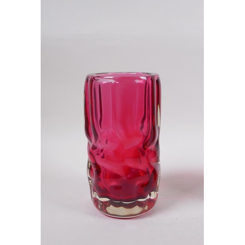 298 - An amethyst studio glass vase and a similar cranberry studio glass vase, largest 7½