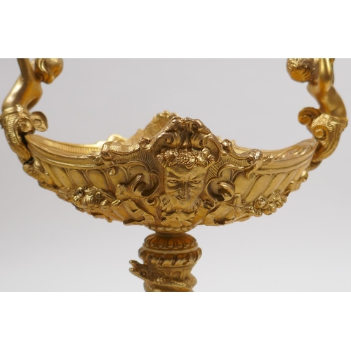 31 - An ormolu centre piece with two handles in the form of putti playing cymbals, 21cm high