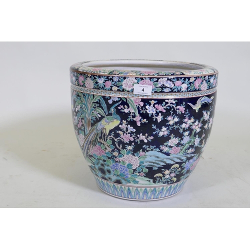 4 - An antique Chinese famille noire ceramic jardiniere, decorated with exotic birds and flowers, 33cm h... 