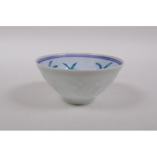 40 - A Doucai porcelain tea bowl with raised lotus flower design to the exterior and floral decoration to... 