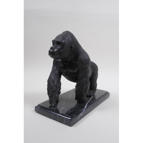 41 - A cast bronze figure of a prowling gorilla, 18cm high