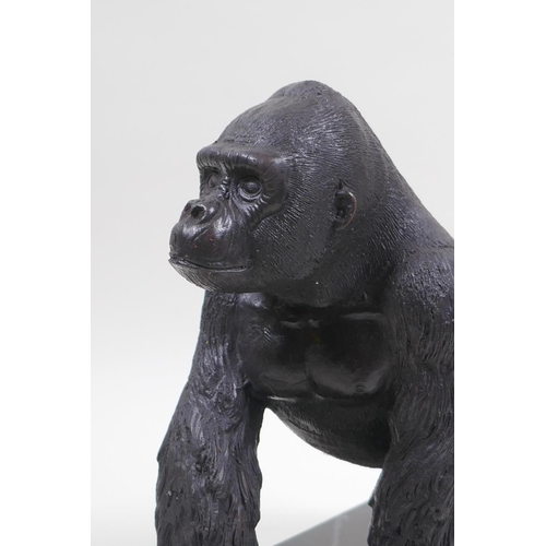 41 - A cast bronze figure of a prowling gorilla, 18cm high