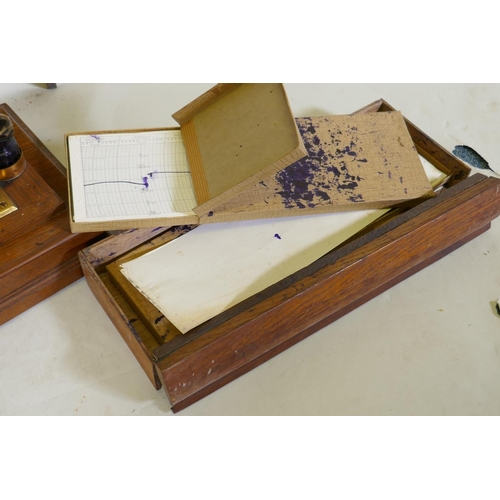 5 - A brass barograph in a glazed oak case with wall bracket fitted with a drawer, glass cracked, drawer... 