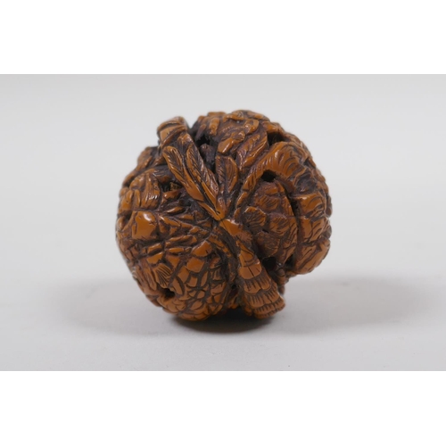 53 - A Chinese carved walnut kernel with figural decoration, 4cm diameter