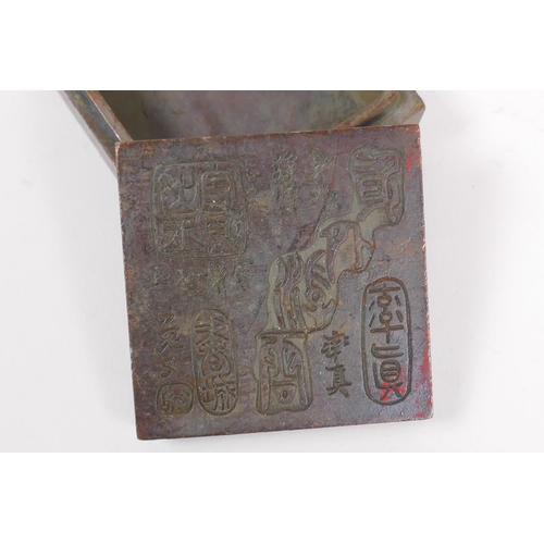 55 - A Chinese bronze ink box, the cover with impressed character marks, 6 x 6cm