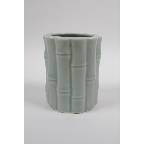 58 - A Chinese celadon glazed porcelain brush pot moulded as bamboo, 12cm high x 10cm diameter 