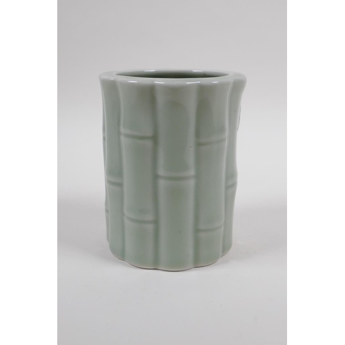 58 - A Chinese celadon glazed porcelain brush pot moulded as bamboo, 12cm high x 10cm diameter 