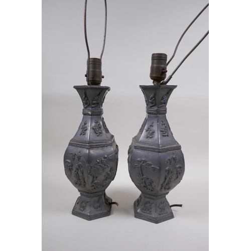 59 - A pair of Chinese pewter lamps decorated with mythical creatures and auspicious symbols, 35cm high e... 