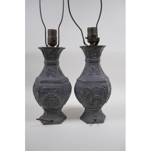 59 - A pair of Chinese pewter lamps decorated with mythical creatures and auspicious symbols, 35cm high e... 