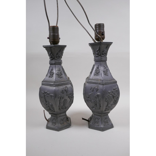 59 - A pair of Chinese pewter lamps decorated with mythical creatures and auspicious symbols, 35cm high e... 