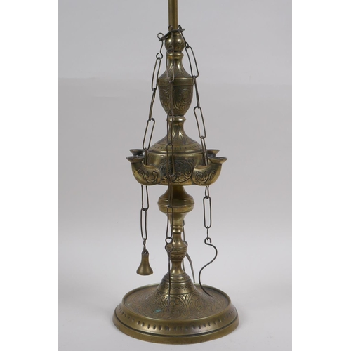 65 - A middle eastern brass four branch whale lamp converted to electricity, 55cm high