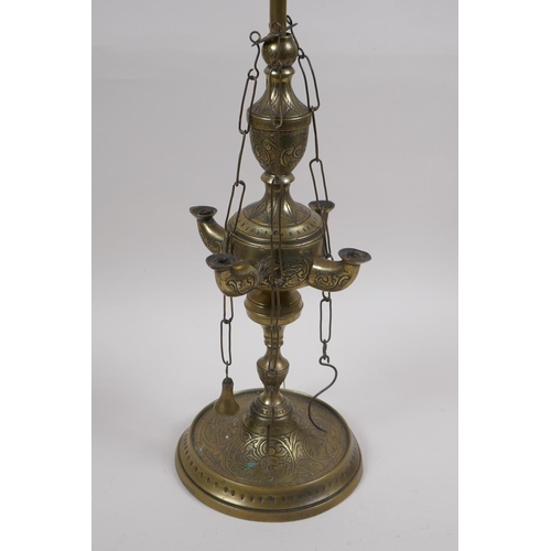 65 - A middle eastern brass four branch whale lamp converted to electricity, 55cm high