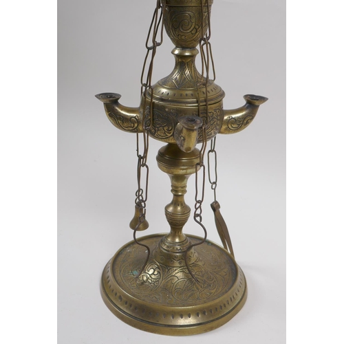 65 - A middle eastern brass four branch whale lamp converted to electricity, 55cm high