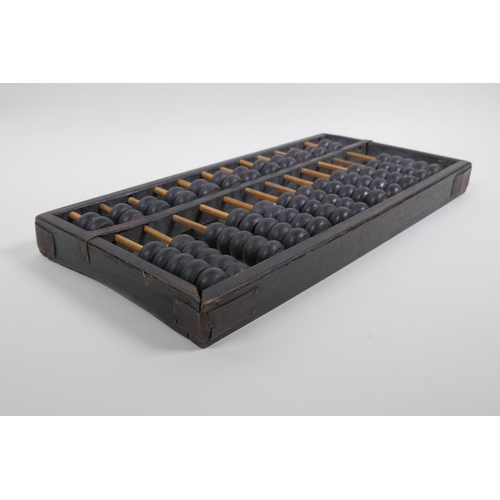 66 - A Chinese hardwood abacus with metal straps, 38 x 19cm