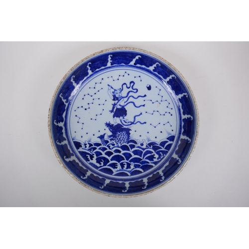 70 - A Chinese blue and white porcelain charger decorated with an immortal riding a carp, 29cm diameter