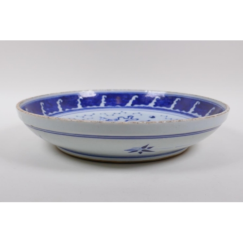 70 - A Chinese blue and white porcelain charger decorated with an immortal riding a carp, 29cm diameter