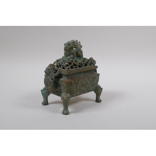 73 - A Chinese bronze censer and pierced cover with two handles and kylin knop, 6 character mark to base,... 