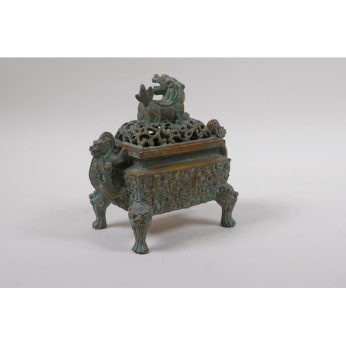 73 - A Chinese bronze censer and pierced cover with two handles and kylin knop, 6 character mark to base,... 