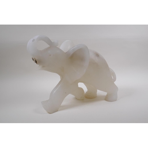 74 - A large carved alabaster elephant, lacks tusks, 35cm long