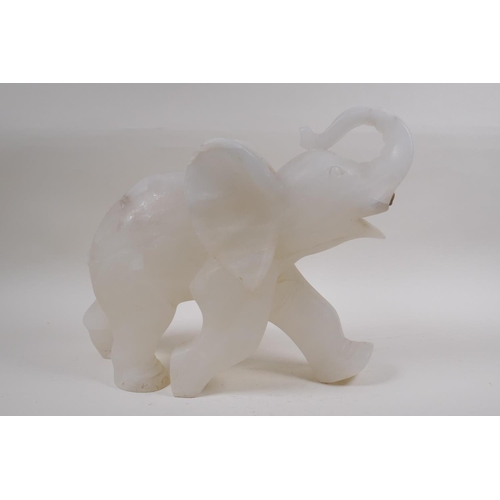 74 - A large carved alabaster elephant, lacks tusks, 35cm long