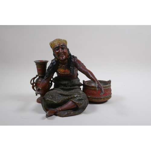 76 - A painted spelter figure of a seated Moorish girl, 22cm wide, 18cm high 