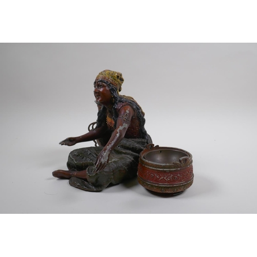 76 - A painted spelter figure of a seated Moorish girl, 22cm wide, 18cm high 