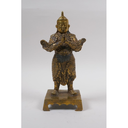 85 - A Sino Tibetan gilt bronze of a contemplative warrior, character marks verso, 22cm high