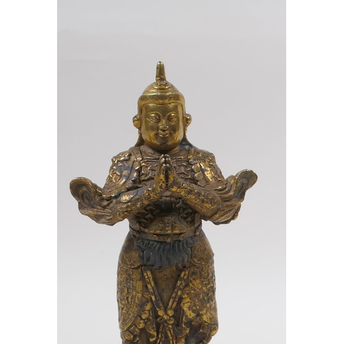 85 - A Sino Tibetan gilt bronze of a contemplative warrior, character marks verso, 22cm high