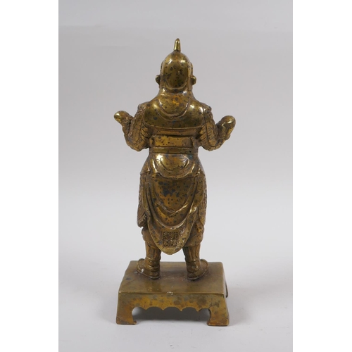 85 - A Sino Tibetan gilt bronze of a contemplative warrior, character marks verso, 22cm high