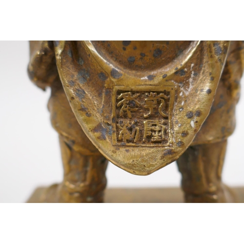 85 - A Sino Tibetan gilt bronze of a contemplative warrior, character marks verso, 22cm high