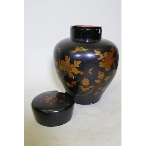 87 - An oriental lacquer storage jar, with internal cover and finely painted gilt decoration, 48cm high