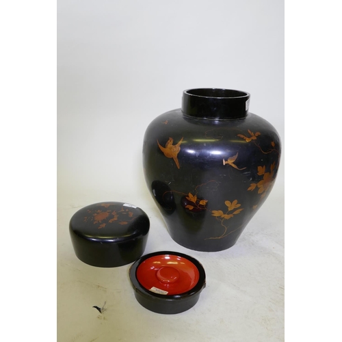 87 - An oriental lacquer storage jar, with internal cover and finely painted gilt decoration, 48cm high