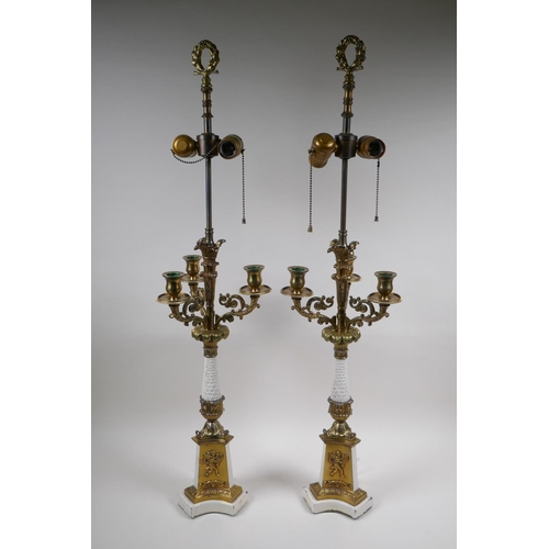 90 - A pair of painted and gilt white metal three branch table lamps converted to electricity, 84cm high