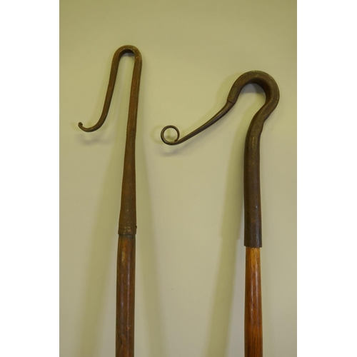 97 - An antique shepherd's crook with blacksmith forged crook, 202cm long, and another similar and smalle... 