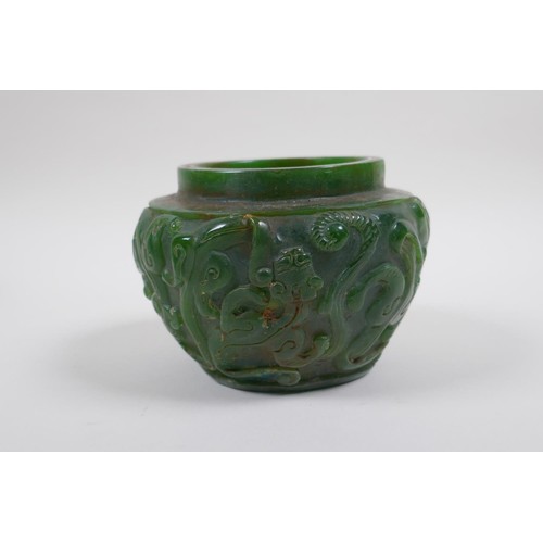 43 - A Chinese reconstitued green hardstone pot with kylin decoration, 13cm diameter