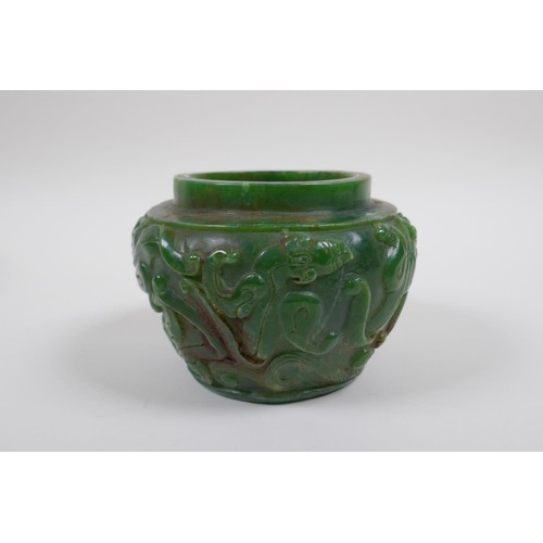 43 - A Chinese reconstitued green hardstone pot with kylin decoration, 13cm diameter