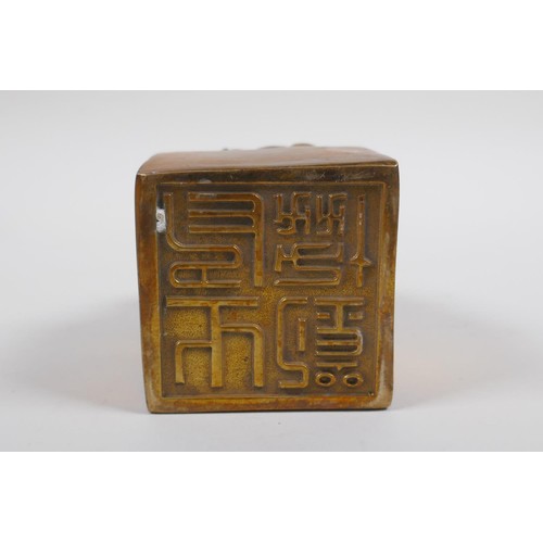 38 - A Chinese filled bronze seal, the mount moulded in the form of three goats with stone set eyes, 6 x ... 