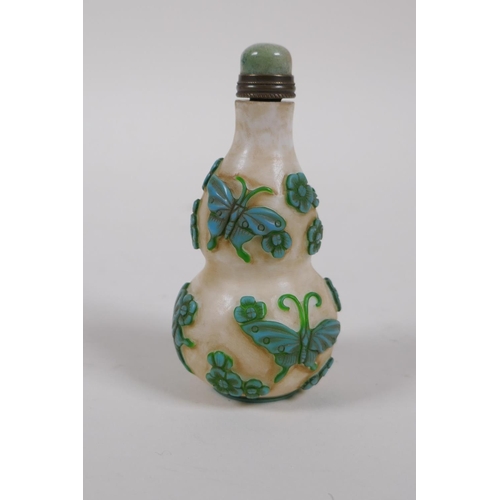 305 - A Peking glass double gourd snuff bottle with raised butterfly decoration, 4 character mark to base,... 