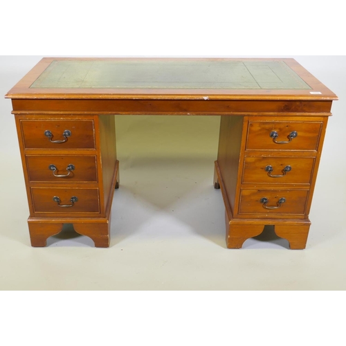 1107 - A yew wood five drawer pedestal desk with leather inset top, raised on bracket supports, 122 x 61 x ... 