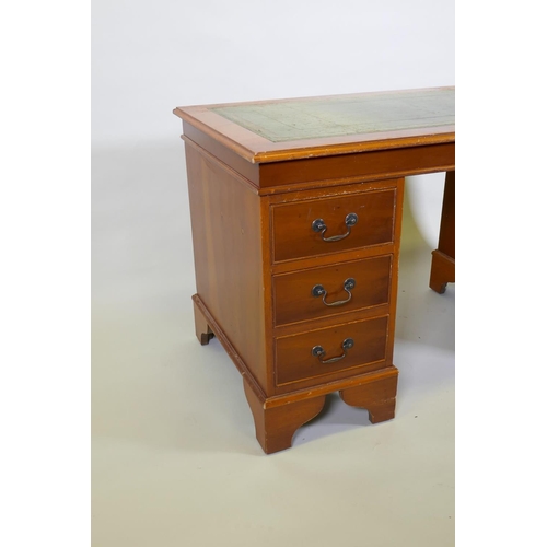 1107 - A yew wood five drawer pedestal desk with leather inset top, raised on bracket supports, 122 x 61 x ... 