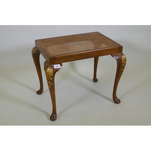 1093 - A Georgian style walnut stool with carved and parcel gilt decoration and cane seat, 56 x 41cm, 45cm ... 