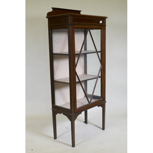 1087 - An Edwardian inlaid mahogany single door display cabinet, raised on tapering supports, 62 x 33 x 42c... 