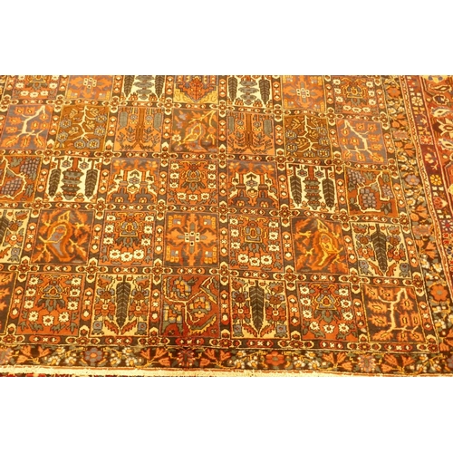 1097 - A Persian Bakhtiar multi-colour ground carpet, with Persian panel design, 335 x 250cm