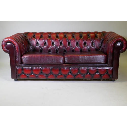 1003 - A button back leather Chesterfield sofa bed, 190cm high