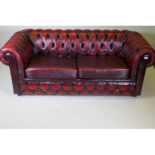 1003 - A button back leather Chesterfield sofa bed, 190cm high