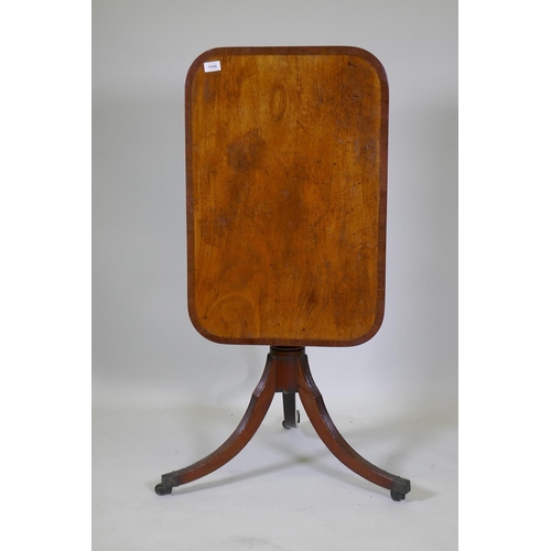 1008 - A Georgian mahogany tilt top table with crossbanded top, turned column and reeded supports, 73 x 49c... 