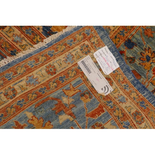 1010 - An Afghan hand woven and knotted Choeb Rang carpet, geometric designs in a muted palette on a blue f... 