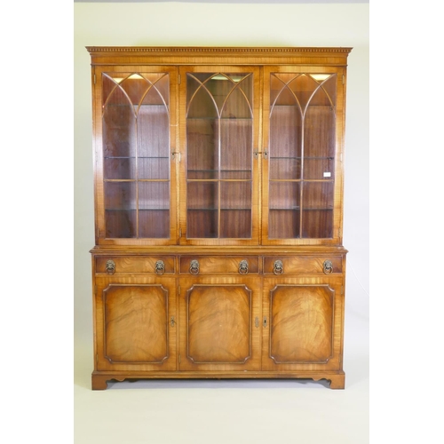 1012 - A Georgian style mahogany bookcase/display cabinet, the upper section with dentil cornice, astragal ... 