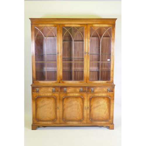 1012 - A Georgian style mahogany bookcase/display cabinet, the upper section with dentil cornice, astragal ... 