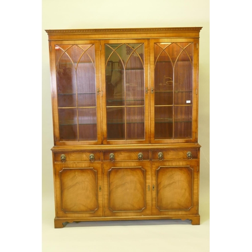 1012 - A Georgian style mahogany bookcase/display cabinet, the upper section with dentil cornice, astragal ... 